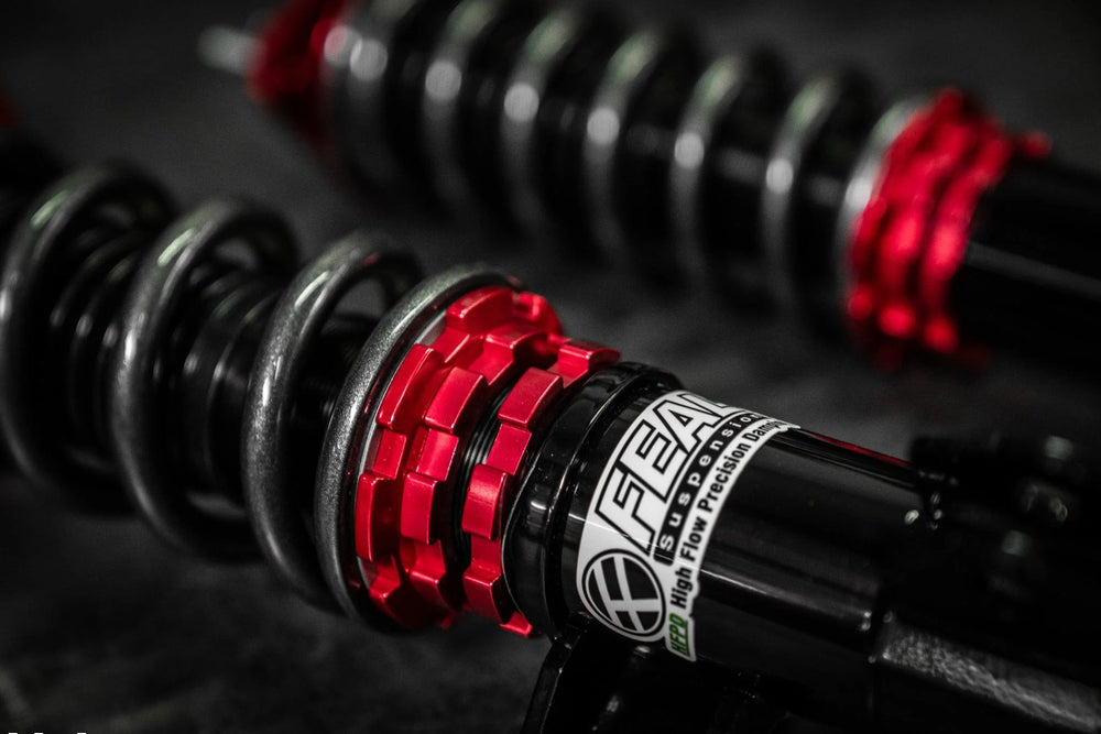 FEAL performance coilover suspension with black springs and red adjustment collars
